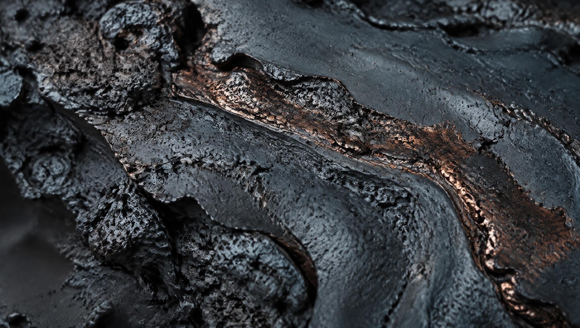 Macro detail of cooled metallurgical material with metallic veining
